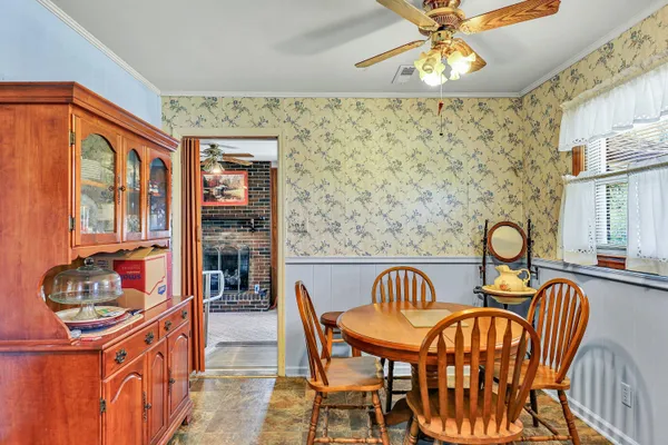 a view of a dining room with furniture and chandelier