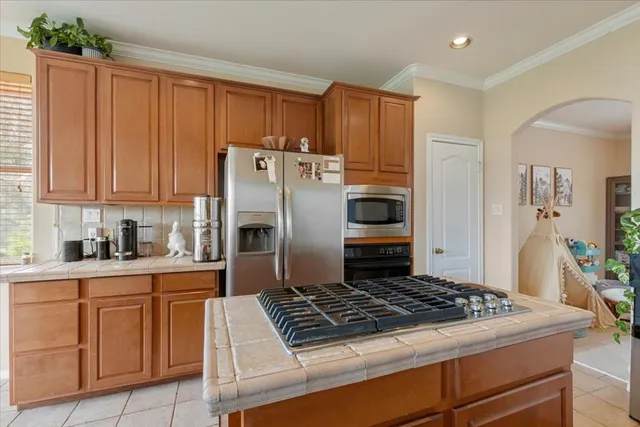 a kitchen with white cabinets and appliances