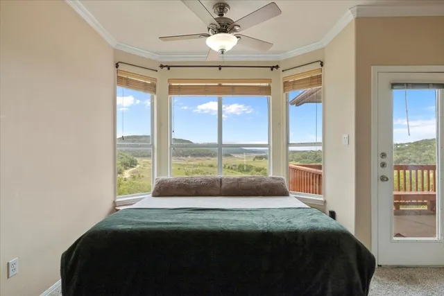 a bedroom with a large bed and a large window