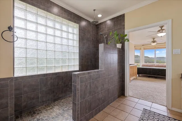 a bathroom with a glass shower door and a bathtub