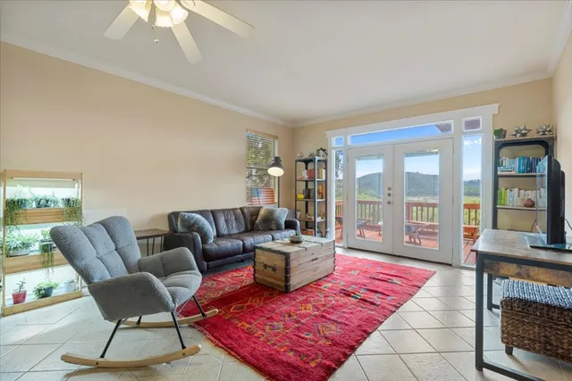 a living room with furniture and a floor to ceiling window