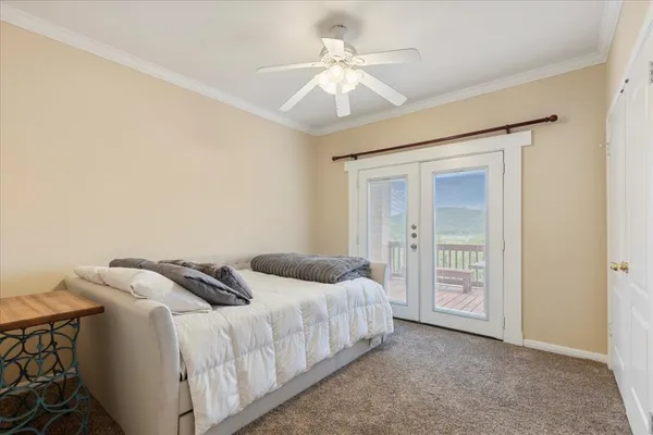 a bedroom with a bed and a ceiling fan