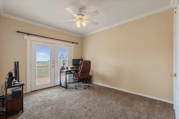 a view of a workspace with furniture and a window