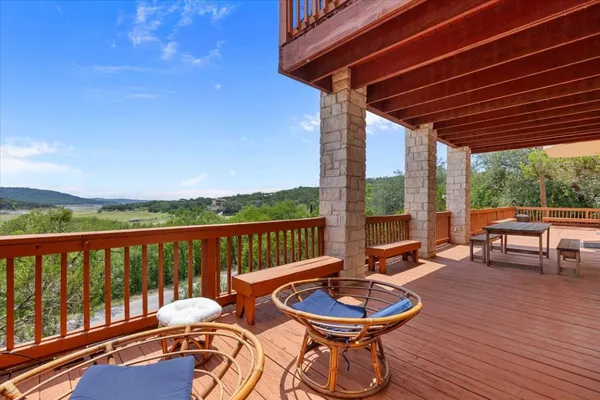 a balcony with chairs and wooden floor