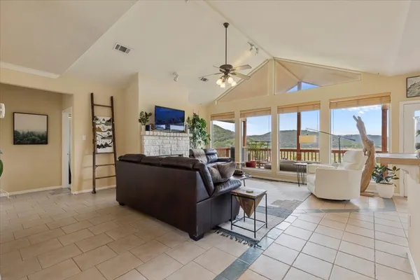 a living room with fireplace furniture and a large window