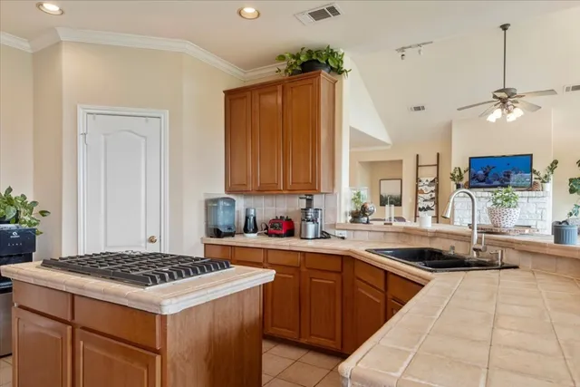 a kitchen with a sink stove and cabinets