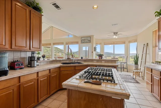 a kitchen with stainless steel appliances a stove a sink dishwasher and cabinets with wooden floor