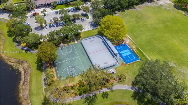 an aerial view of a residential houses with outdoor space and swimming pool