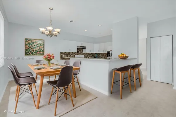 a view of a dining room with furniture and chandelier