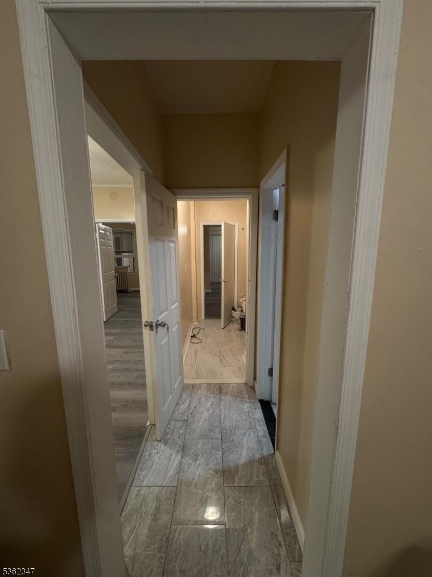 388 East 9th Avenue, Unit 2 Roselle, NJ 07203 - Photo 17 of 24 a view of a hallway with wooden shelves