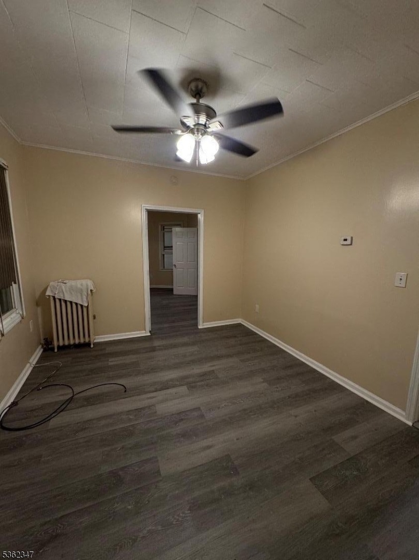 388 East 9th Avenue, Unit 2 Roselle, NJ 07203 - Photo 20 of 24 a view of an empty room with wooden floor and a ceiling fan
