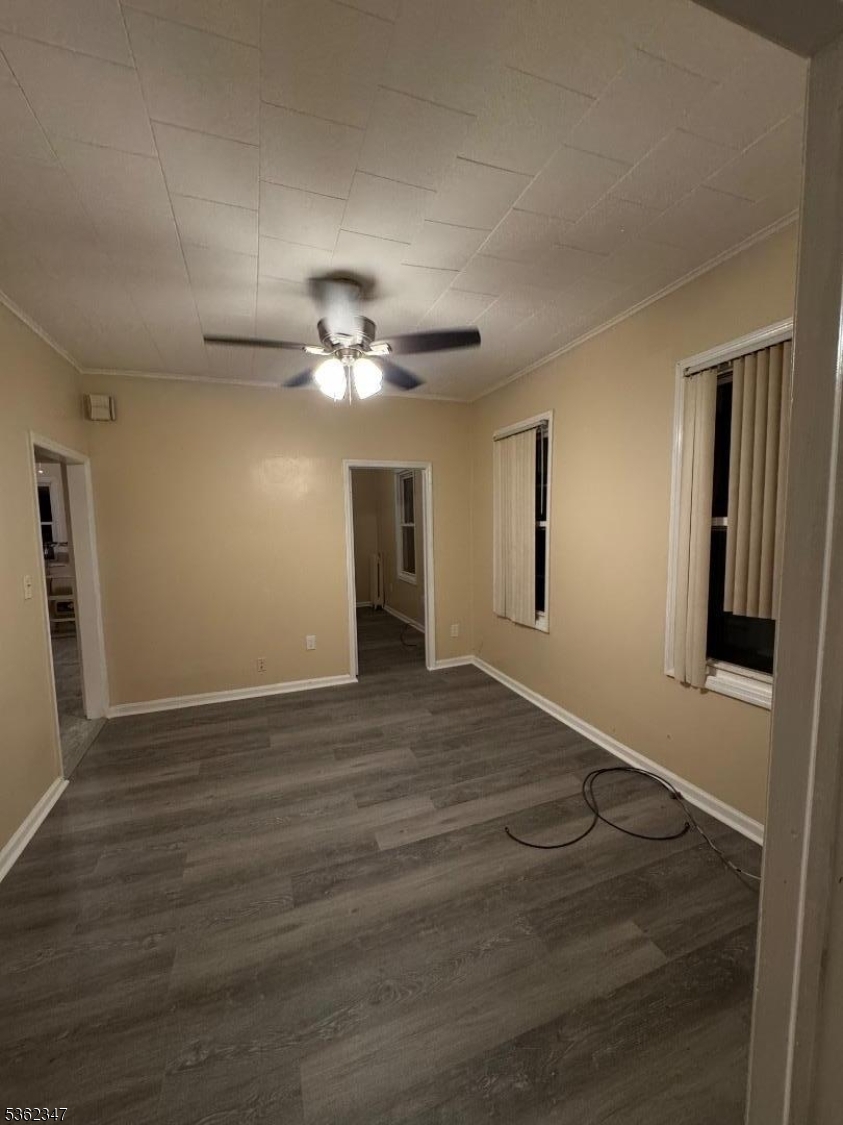 388 East 9th Avenue, Unit 2 Roselle, NJ 07203 - Photo 7 of 24 a view of an empty room with wooden floor and fan