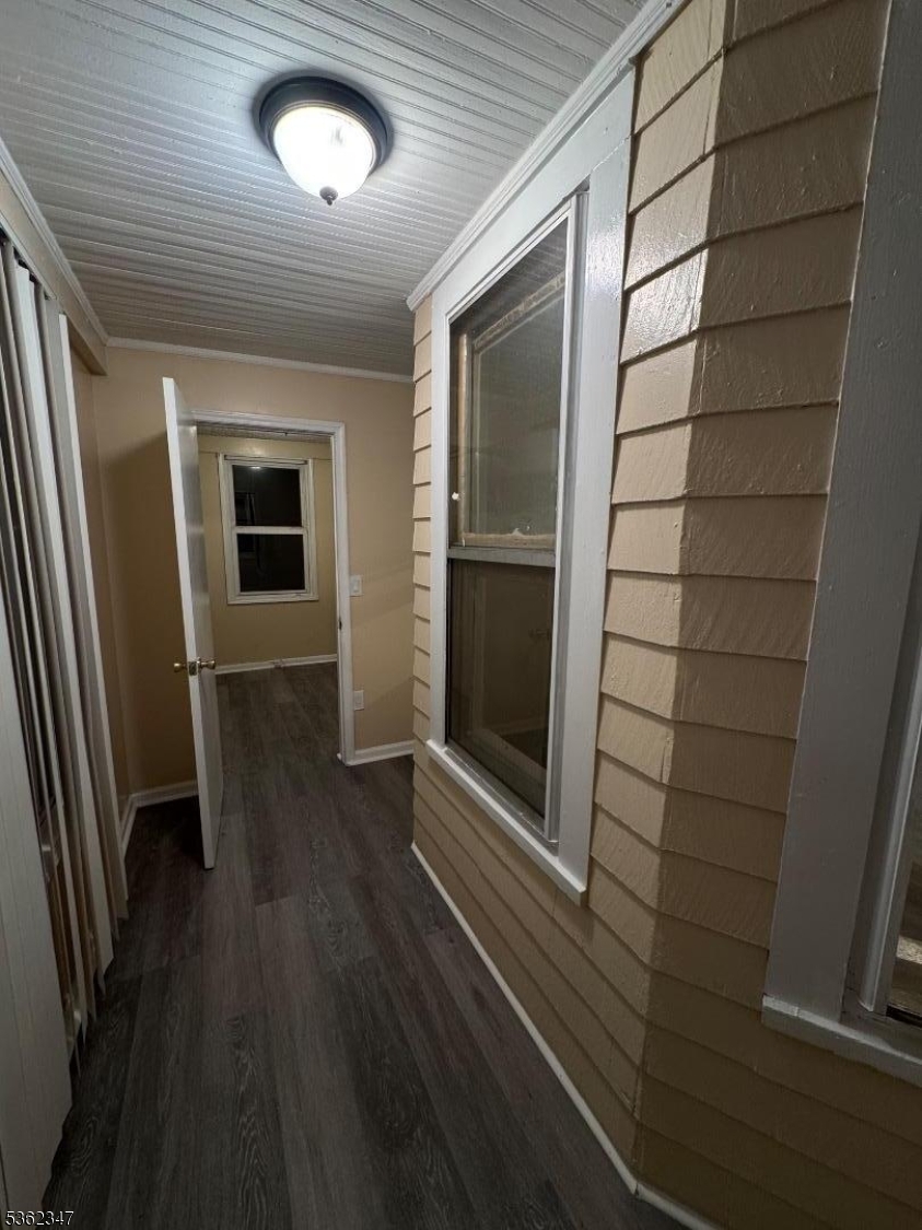 388 East 9th Avenue, Unit 2 Roselle, NJ 07203 - Photo 10 of 24 a view of a hallway with wooden floor and a large window
