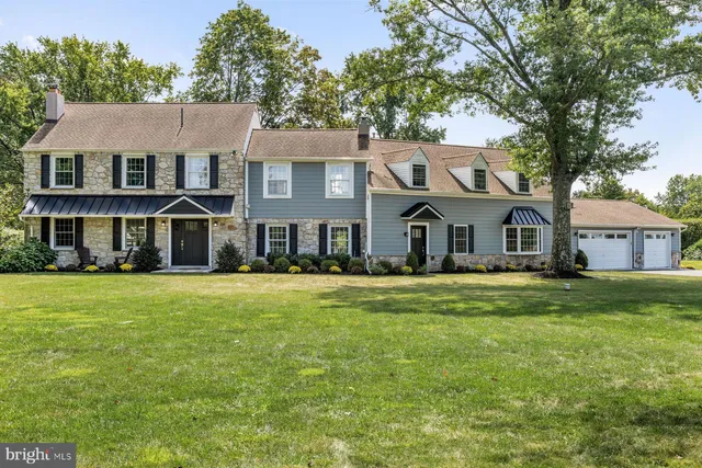 a front view of a house with a garden and porch