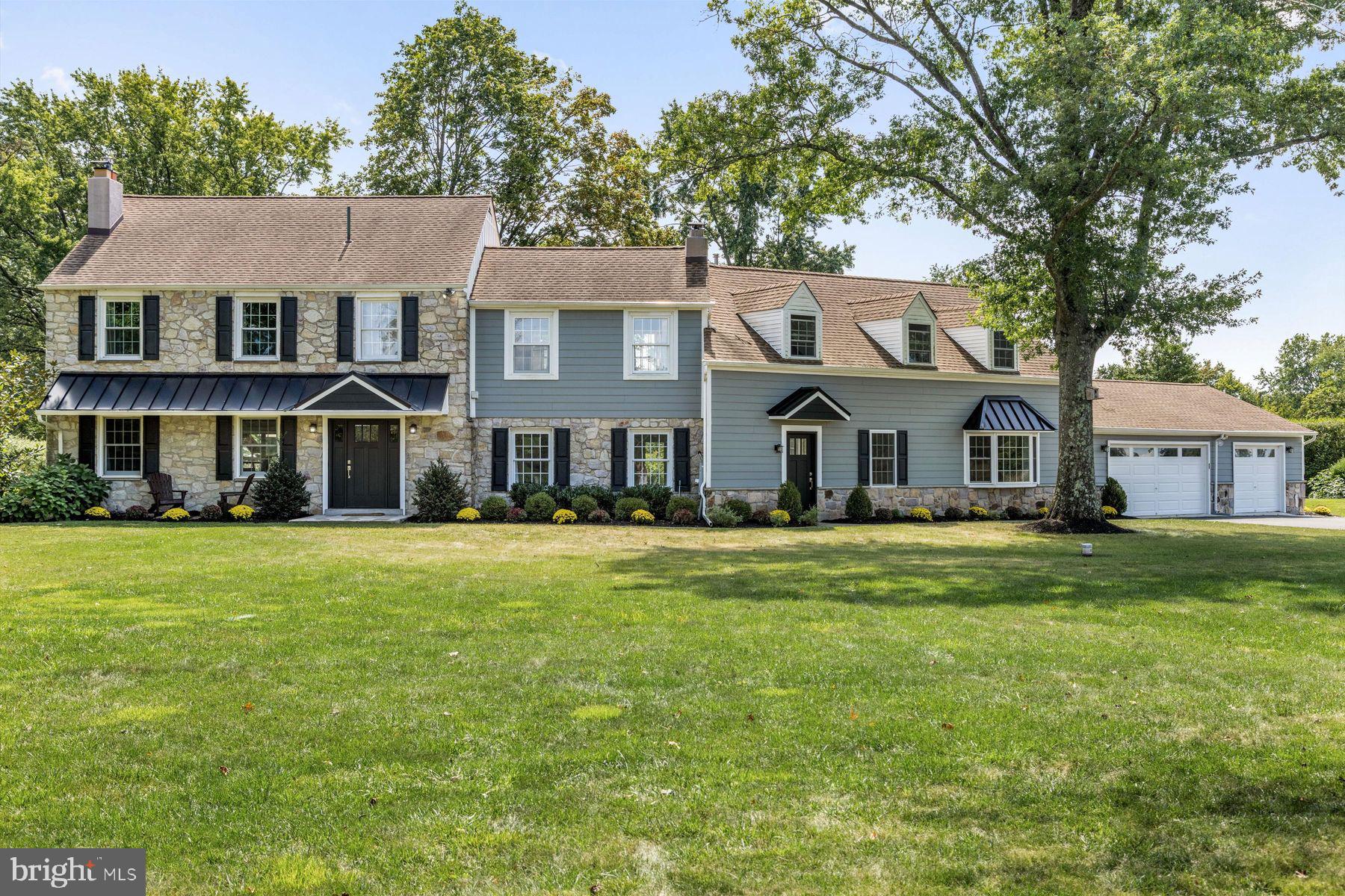 a front view of a house with a garden and porch