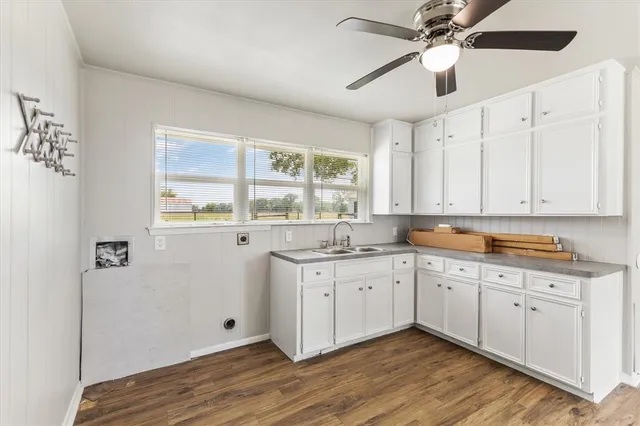 a kitchen with a sink cabinets and window