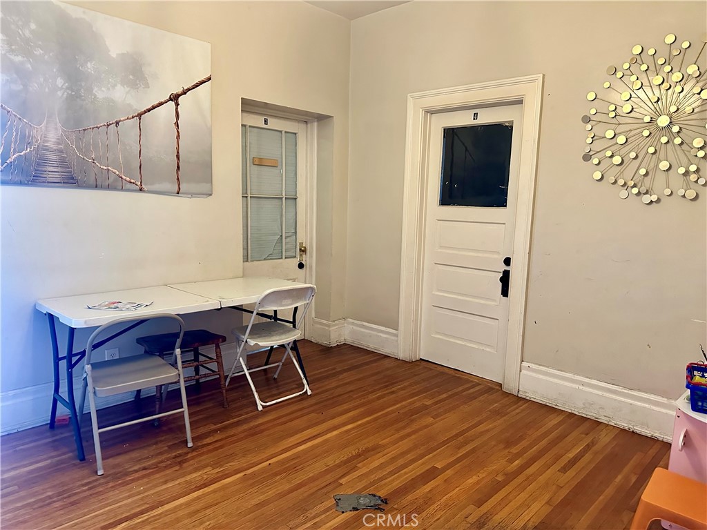 4308 Lime Street Riverside, CA 92501 - Photo 9 of 14 a workspace room with wooden floor and furniture