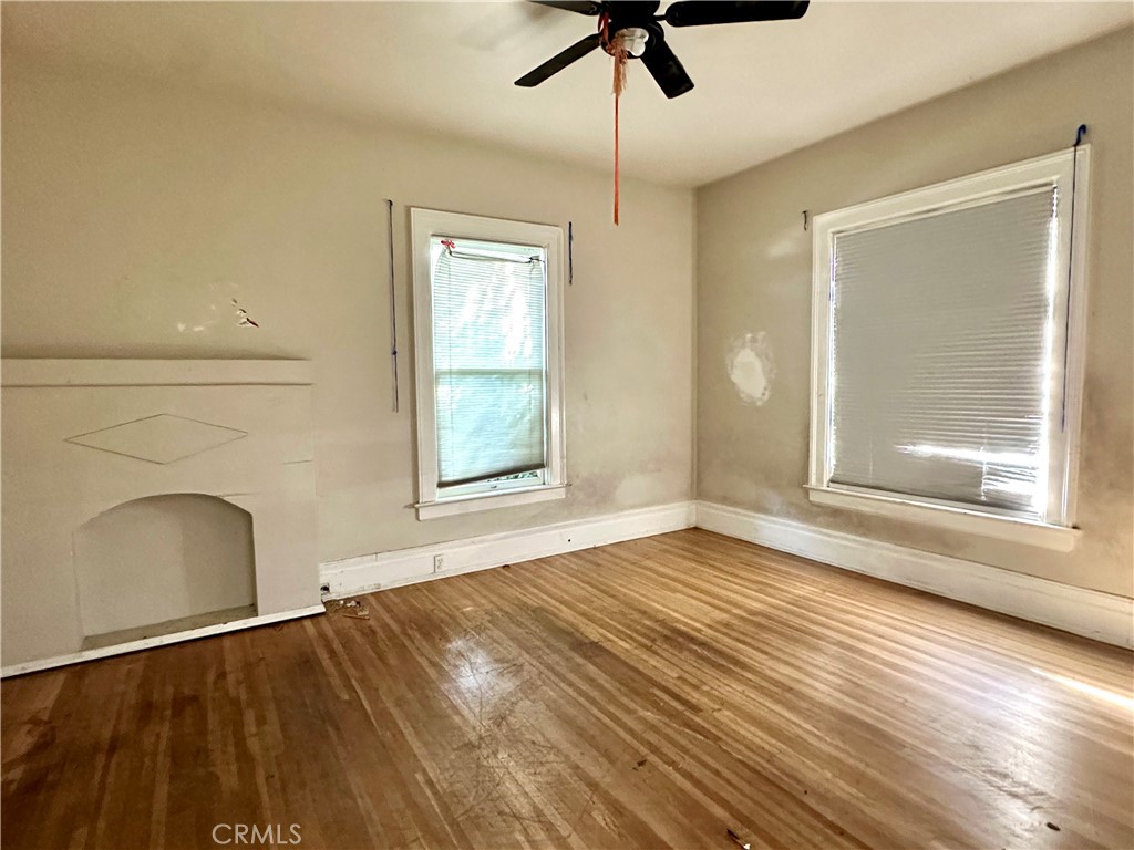 4308 Lime Street Riverside, CA 92501 - Photo 10 of 14 a view of an empty room with a window and wooden floor