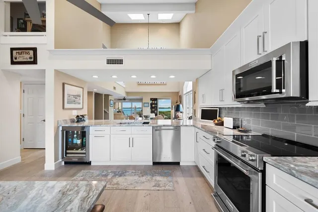 a kitchen with a sink stove and microwave
