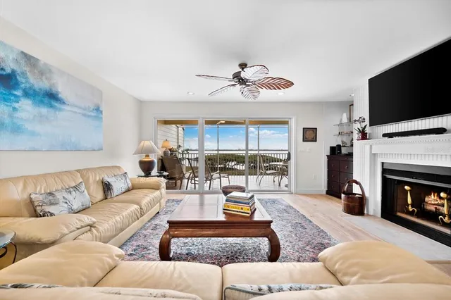 a living room with furniture fireplace and flat screen tv