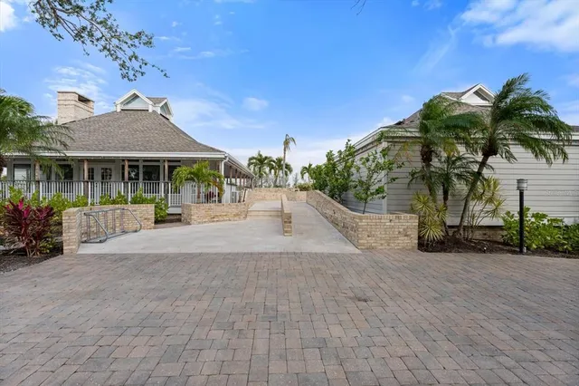a view of a house with a yard and potted plants