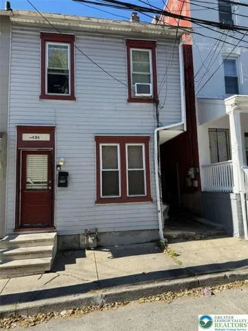 a brick house with a windows on the street