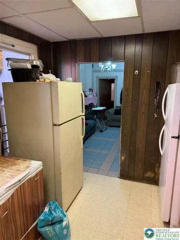 a view of a patio with table and chairs under an umbrella
