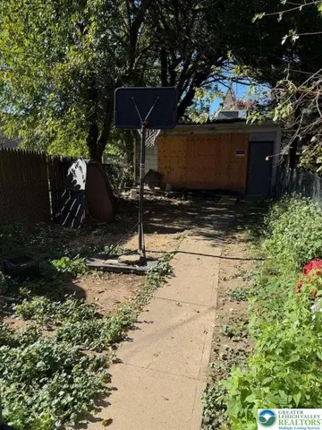 a view of a chairs and table in backyard of the house