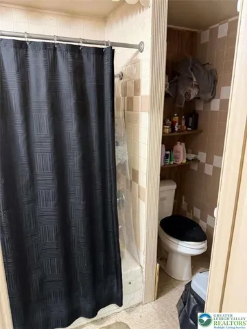 a bedroom with a bed and a chair