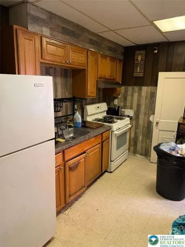 a kitchen with sink a refrigerator and cabinets