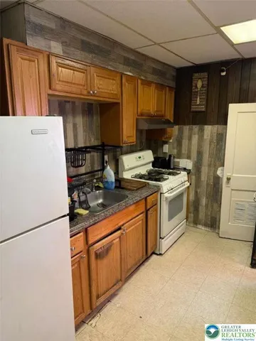a refrigerator freezer sitting inside of a kitchen
