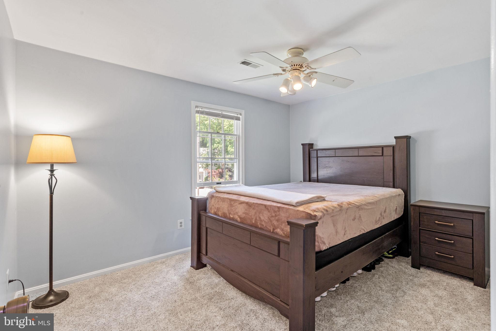 721 Webster Drive Monroeville, NJ 08343 - Photo 16 of 38 a bedroom with a bed and a chandelier