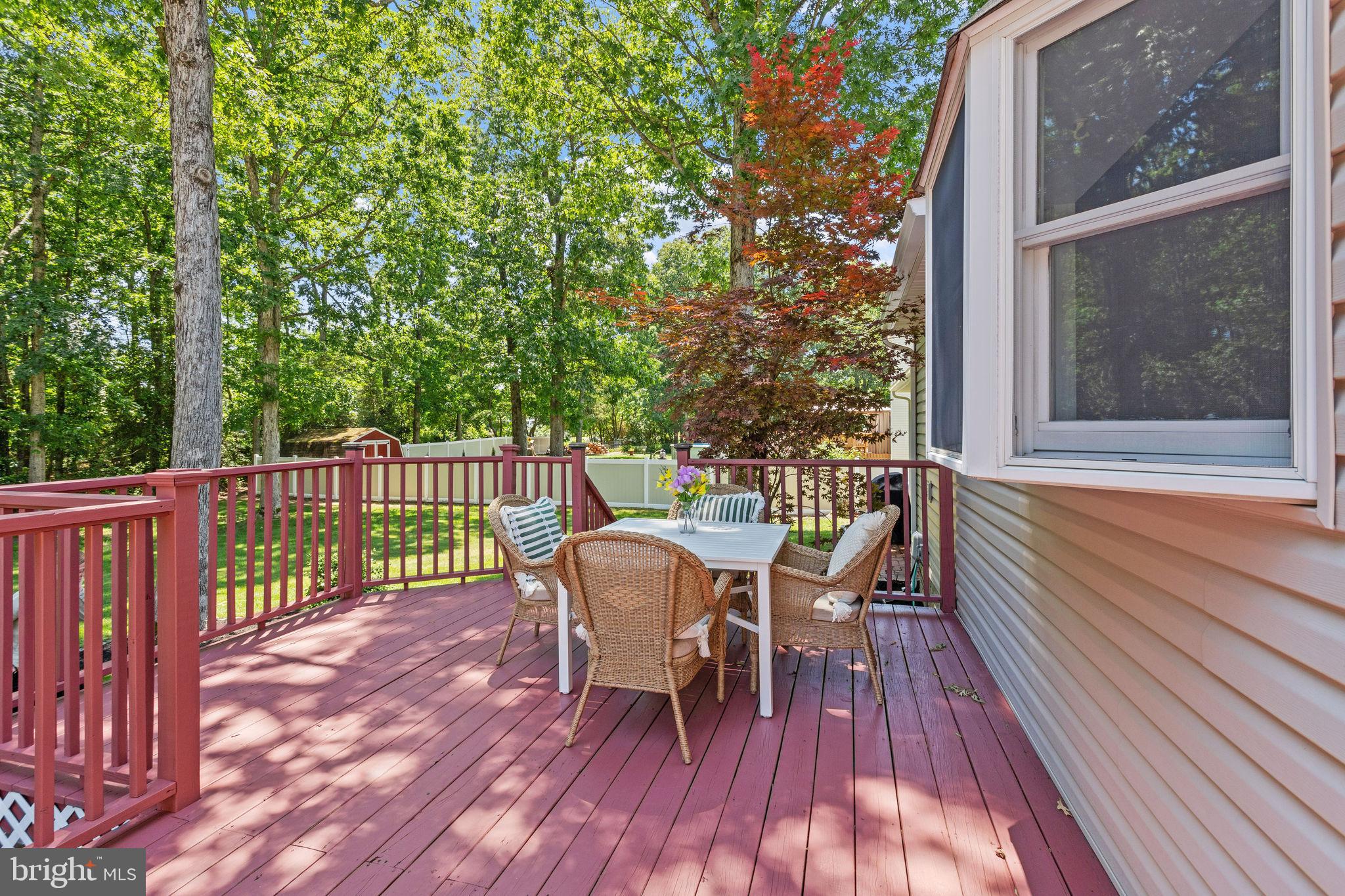 721 Webster Drive Monroeville, NJ 08343 - Photo 25 of 38 a view of a deck with table and chairs and wooden floor