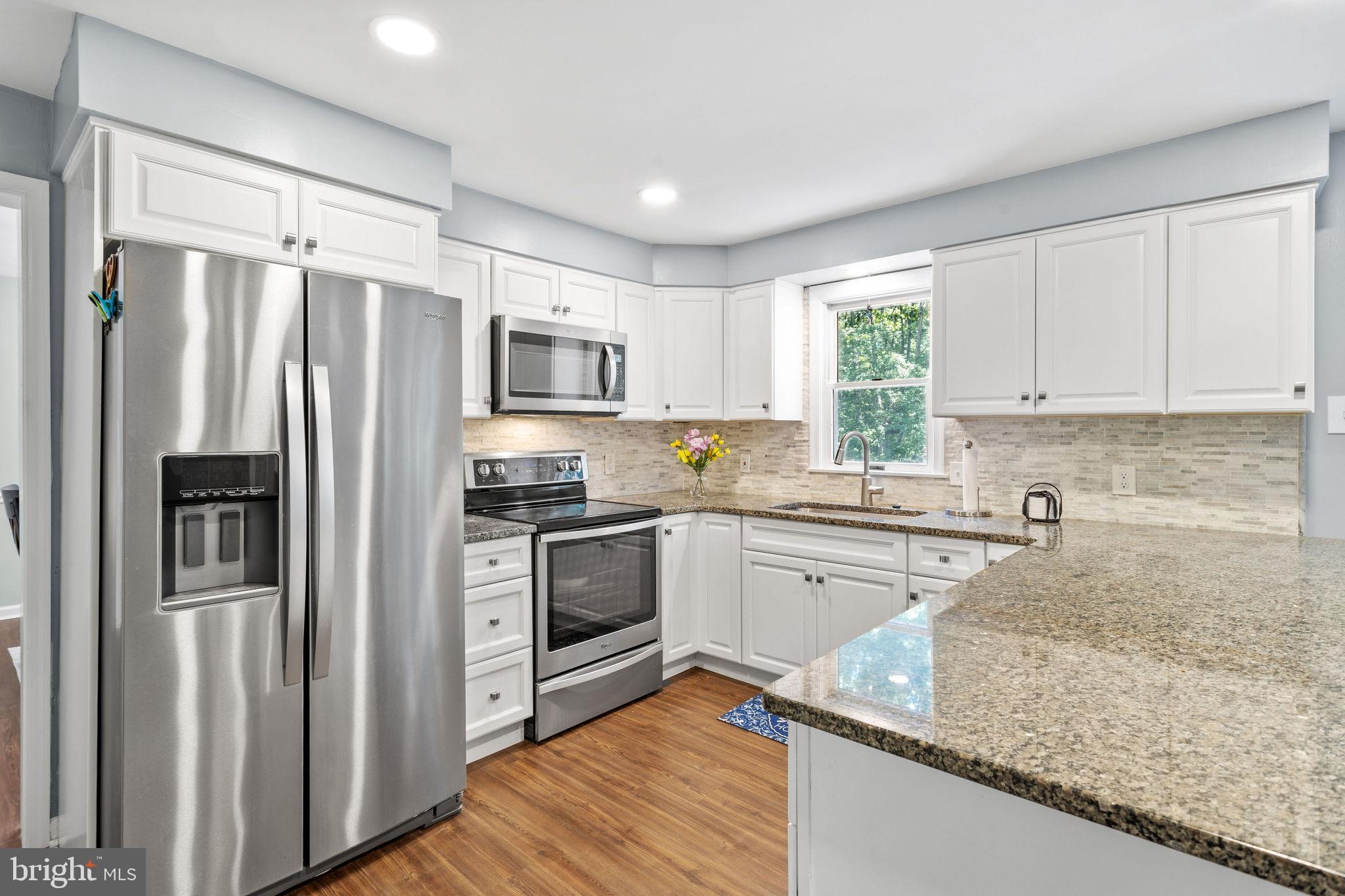 721 Webster Drive Monroeville, NJ 08343 - Photo 6 of 38 a kitchen with kitchen island granite countertop stainless steel appliances cabinets a sink and a counter top space