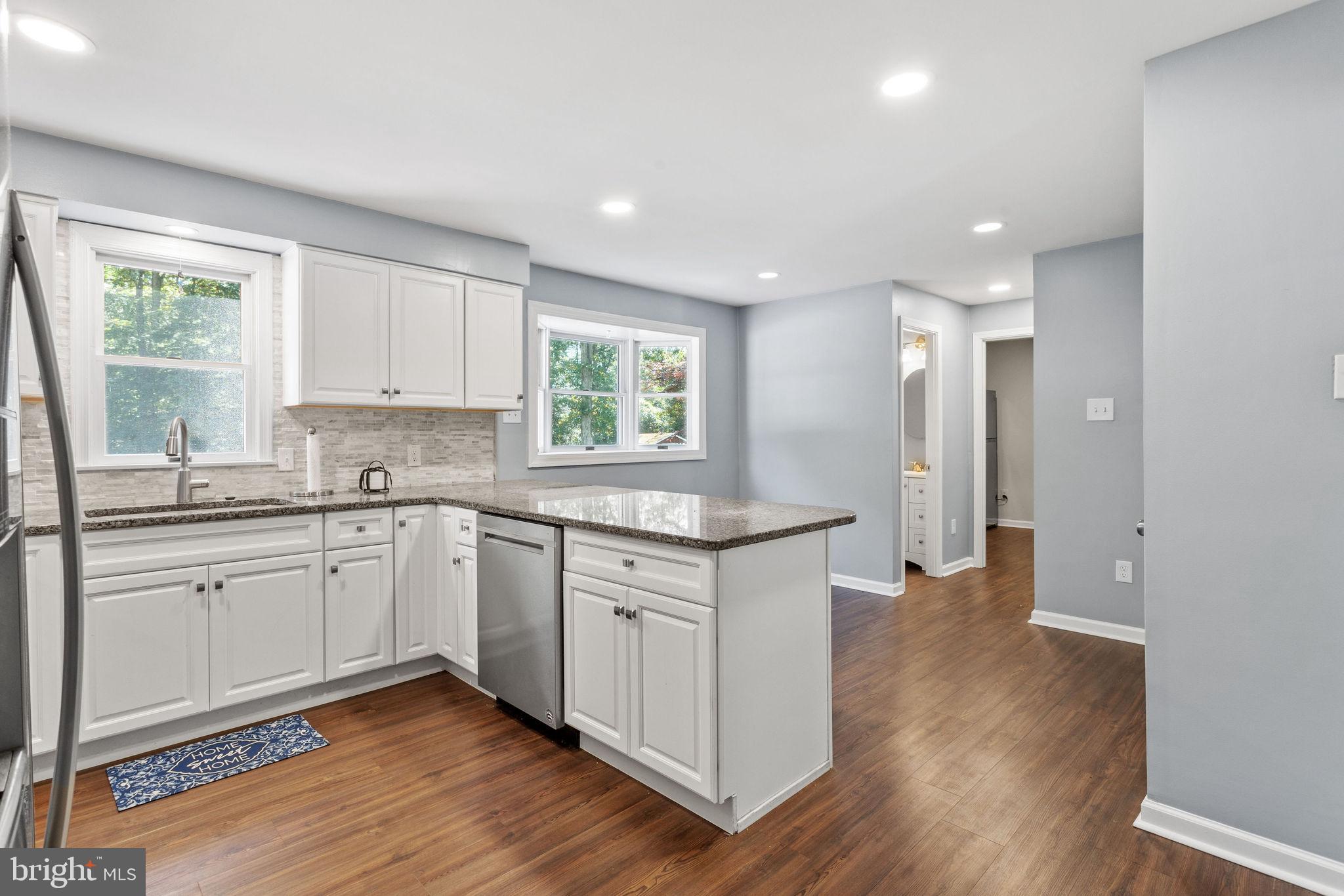 721 Webster Drive Monroeville, NJ 08343 - Photo 7 of 38 a kitchen with granite countertop white cabinets a sink a window and stainless steel appliances