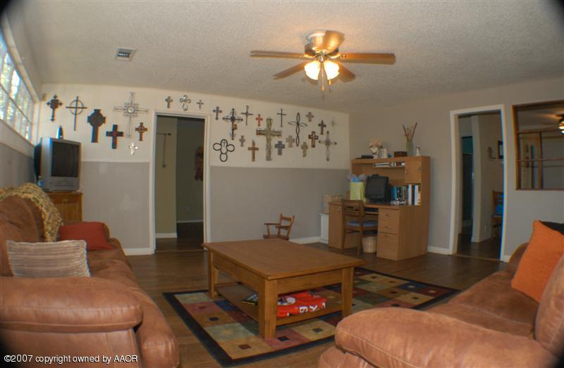 4101 South Monroe Street Amarillo, TX 79110 - Photo 3 of 6 a living room with furniture and a chandelier