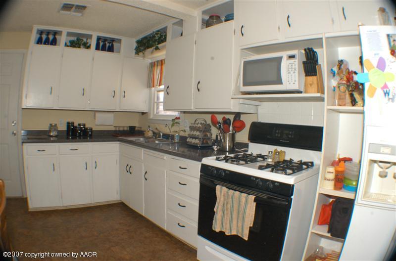 4101 South Monroe Street Amarillo, TX 79110 - Photo 4 of 6 a kitchen with stainless steel appliances a stove a sink and a microwave