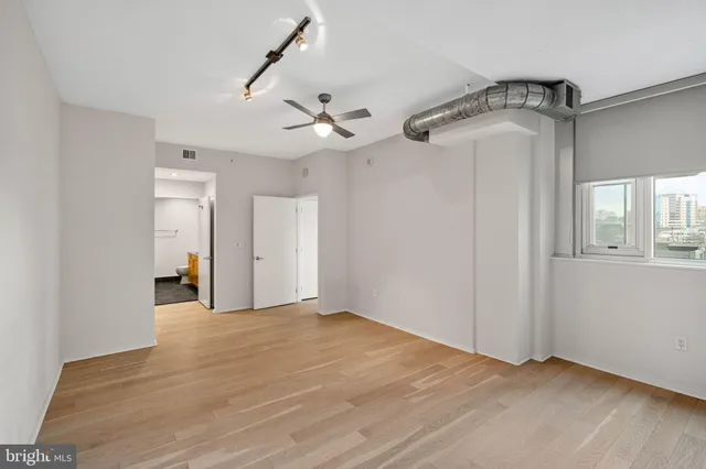 a view of a room with wooden floor
