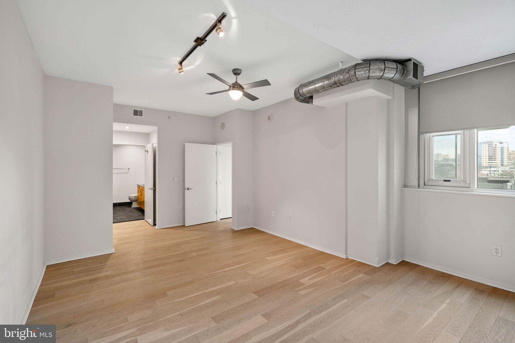 3409 Wilson Boulevard, Unit 301 Arlington, VA 22201 - Photo 14 of 39 a view of empty room with wooden floor and ceiling fan
