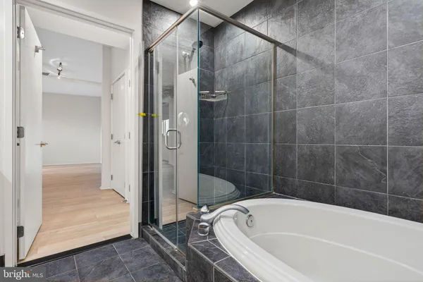 an empty room with wooden floor and cabinet