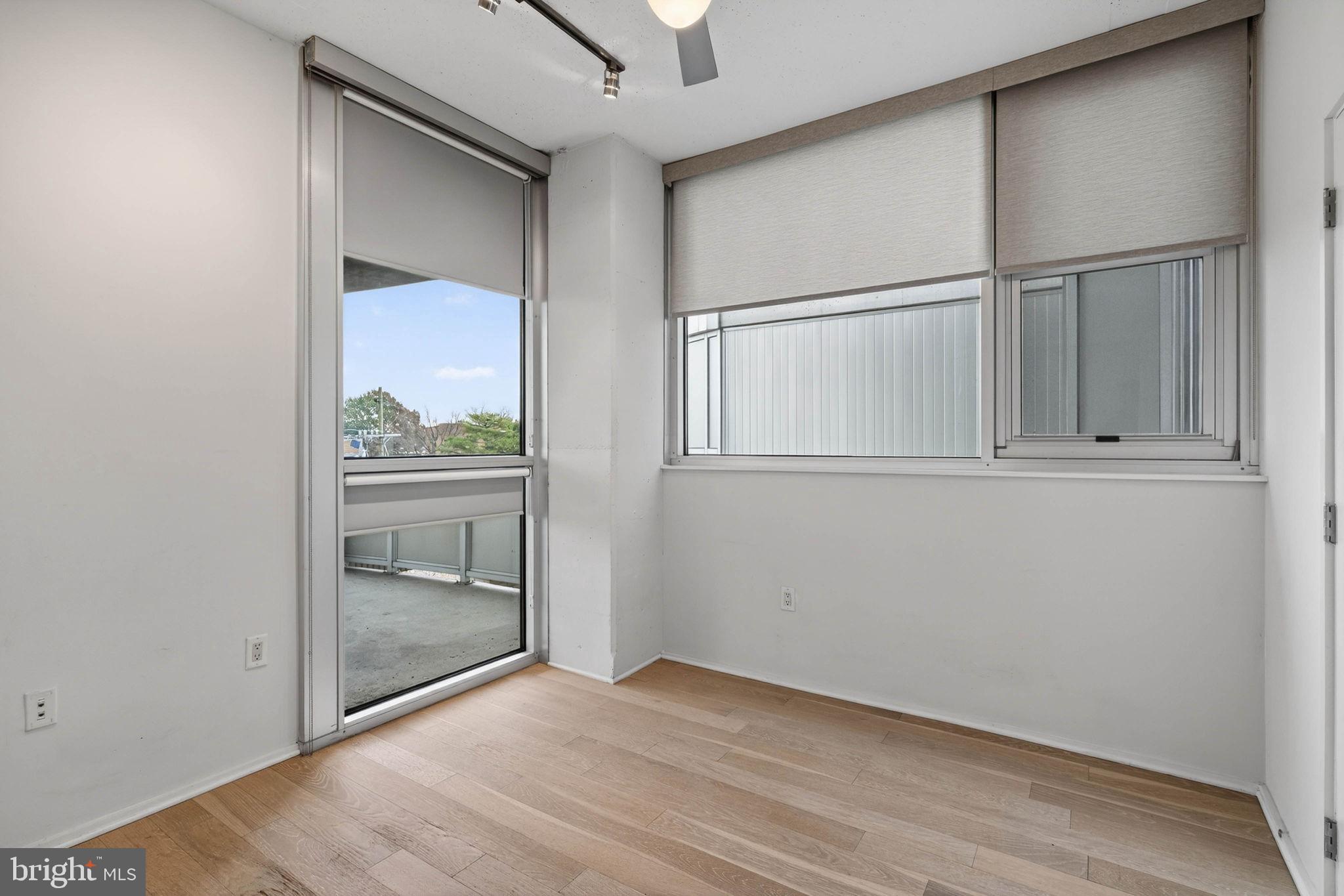 3409 Wilson Boulevard, Unit 301 Arlington, VA 22201 - Photo 20 of 39 an empty room with wooden floor and cabinet