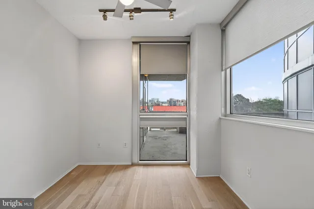 a kitchen with stainless steel appliances granite countertop a sink a counter top space and living room view