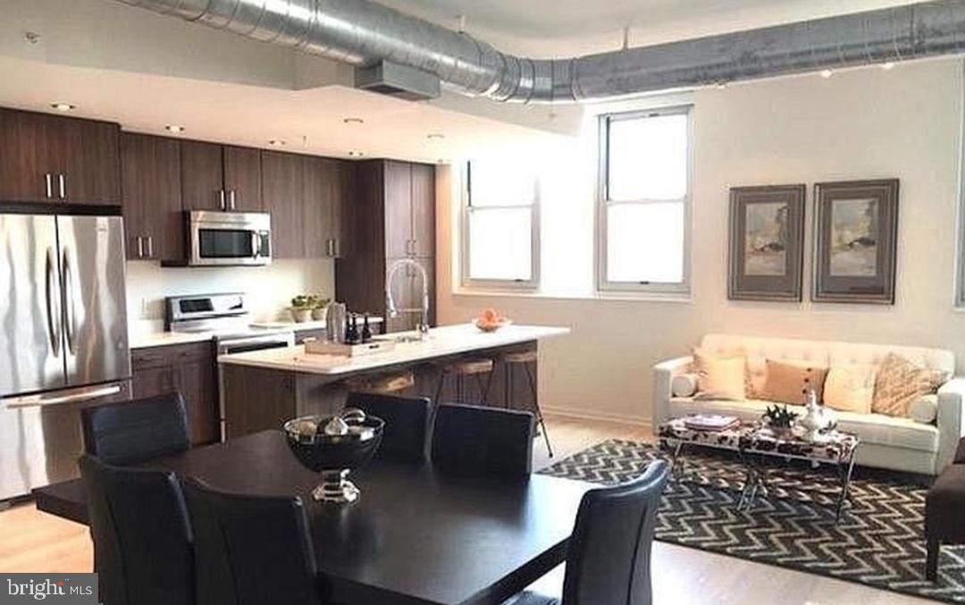 3409 Wilson Boulevard, Unit 301 Arlington, VA 22201 - Photo 32 of 39 a kitchen with stainless steel appliances granite countertop a sink refrigerator and microwave