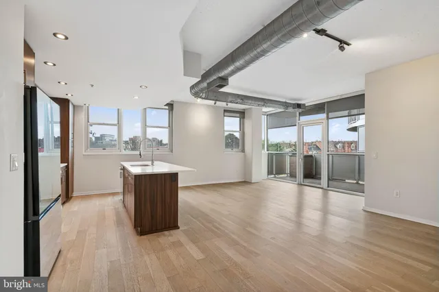 a view of kitchen with stainless steel appliances kitchen island sink refrigerator and stove