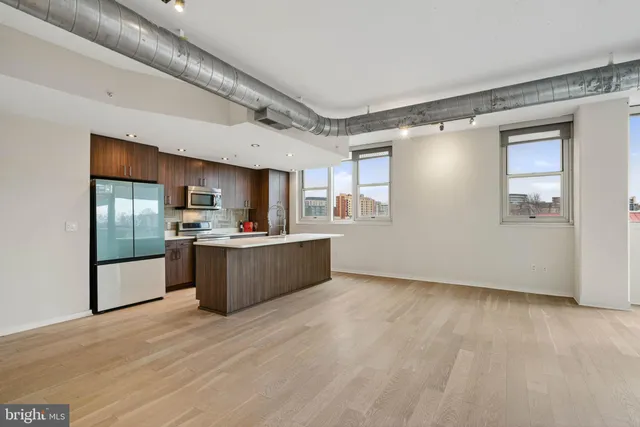 a kitchen that has a sink and a stove in it