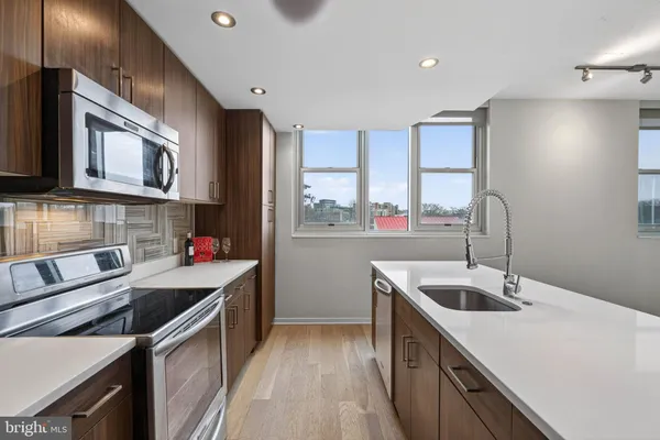 a kitchen that has a sink and a stove in it