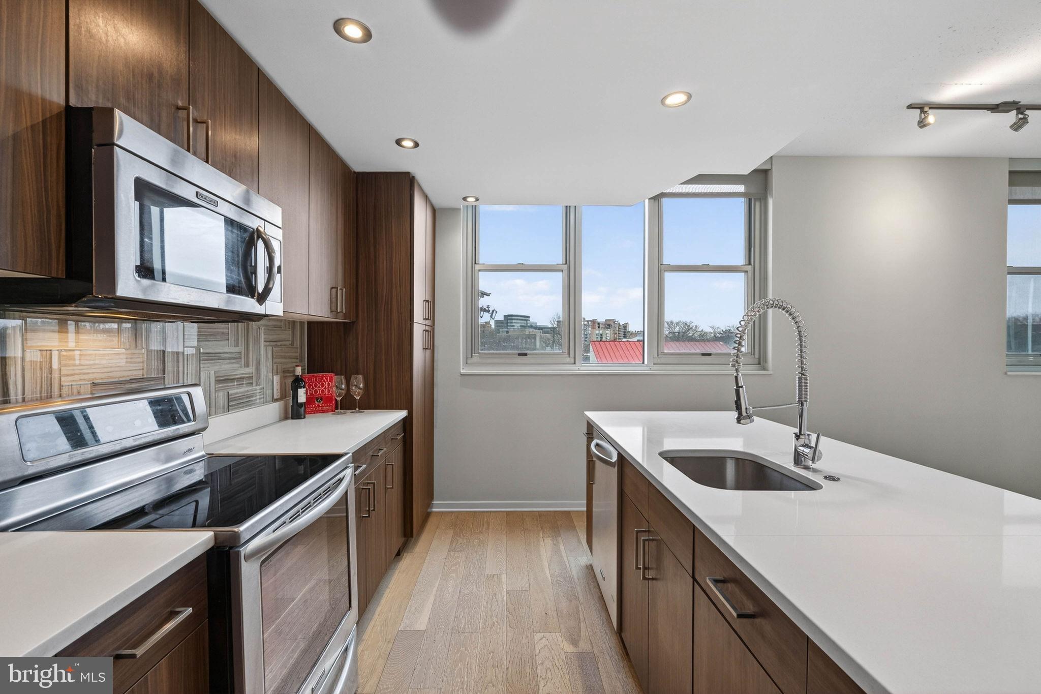 3409 Wilson Boulevard, Unit 301 Arlington, VA 22201 - Photo 8 of 39 a kitchen that has a sink and a stove in it