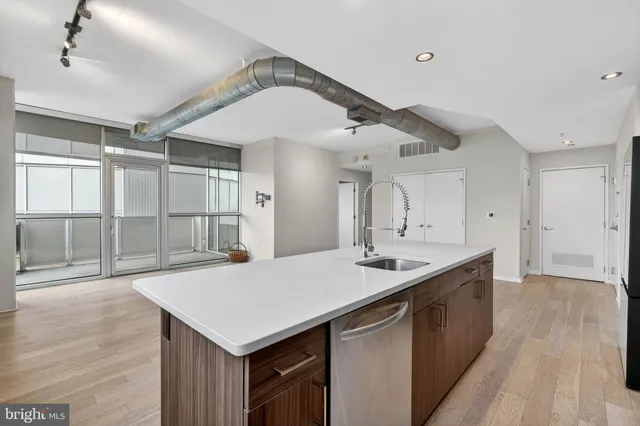 a view of empty room with wooden floor and ceiling fan