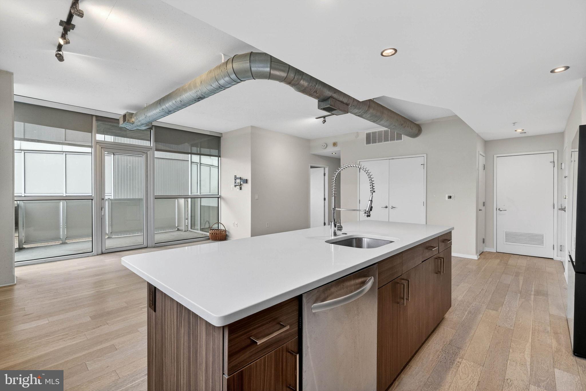 3409 Wilson Boulevard, Unit 301 Arlington, VA 22201 - Photo 9 of 39 a kitchen with a sink a counter space and a refrigerator