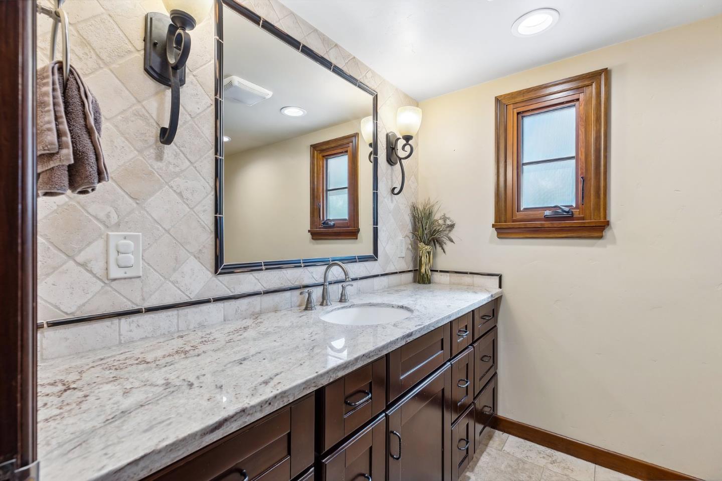 333 Crest Drive San Jose, CA 95127 - Photo 29 of 69 a bathroom with a granite countertop sink a large mirror and vanity